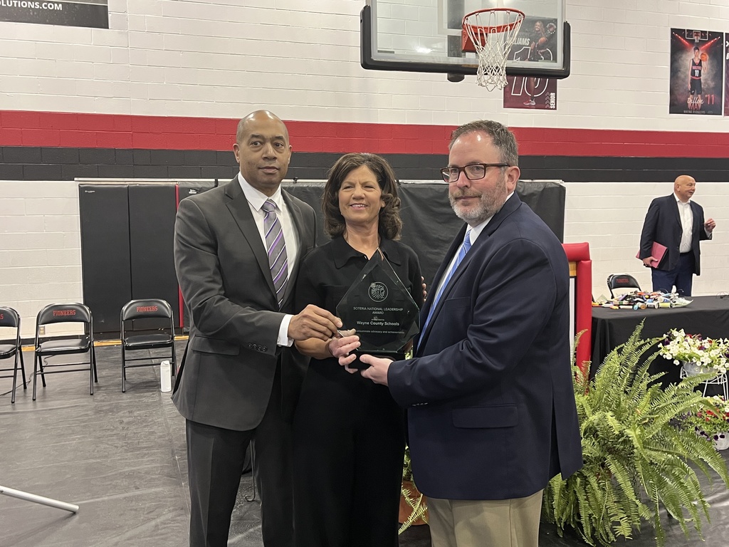 Superintendent Todd Alexander, Principal Sara Stapleton, and Soter CEO Derek Peterson with the Soter Award